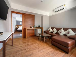 a living room with a couch and a table at Estia Chiangmai in Chiang Mai
