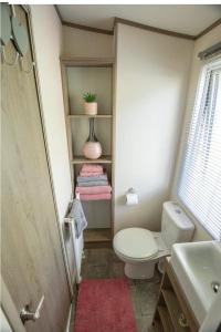 a bathroom with a toilet and a sink at Pepper Pot Lodge in Knaresborough