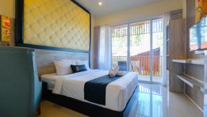 Postel nebo postele na pokoji v ubytování Graha Socio Hotel Nusa Dua Bali