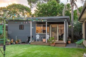 a tiny house with a porch and a yard at Bower On Becket - Couples Retreat in Rye