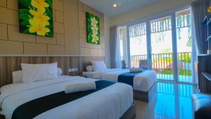 Postel nebo postele na pokoji v ubytování Graha Socio Hotel Nusa Dua Bali