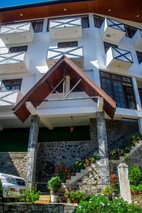 a building with awning and stairs in front of it at MANUDI Glenfallsedge Rest in Nuwara Eliya