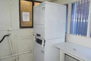 a white refrigerator in a kitchen with a window at Rodeway Inn Encinitas North in Encinitas