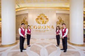 a group of people standing in front of a sign at BISTRO HOTEL Grand World Phú Quốc in Phu Quoc