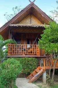 a house with a balcony on the side of it at Pai Homey in Pai