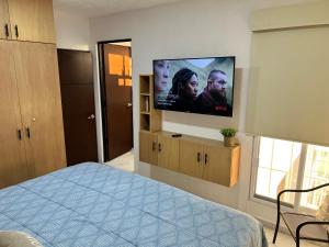 a bedroom with a flat screen tv on the wall at 5E Roof- Penthouse Manzanillo exclusivo con alberca in Manzanillo