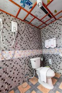 a bathroom with a toilet and a shower at 2U Hotel Hatyai in Hat Yai