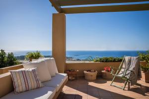 a patio with a couch and a view of the ocean at Villa nonà Maria in Minia