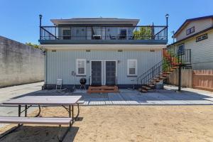 a house with a balcony and a table in front of it at Comfortable 2BR Spacious Deck! 7 mins to Sacramento Downtown and Midtown in Sacramento
