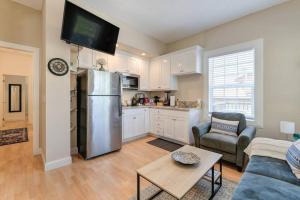 a kitchen with a stainless steel refrigerator in a living room at Comfortable 2BR Spacious Deck! 7 mins to Sacramento Downtown and Midtown in Sacramento