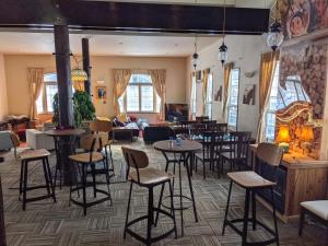 a restaurant with tables and chairs in a room at Luna Lodge in Hakuba