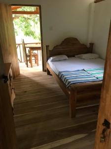 a bedroom with a bed and a wooden floor at Gaga addara resort in Habarana