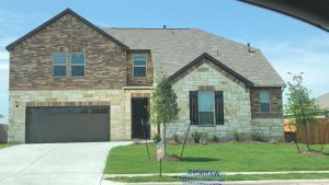 a house with a garage in front of it at Beautiful Home with Modern Rooms in Round Rock