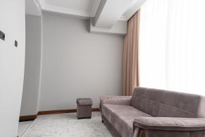 a living room with a couch and a window at Mir Luxe Plaza in Tashkent