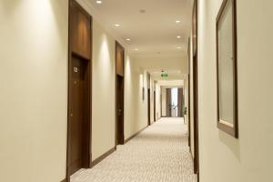 a corridor of a building with a long hallway at Mir Luxe Plaza in Tashkent