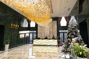 a christmas tree in the lobby of a hotel at Mir Luxe Plaza in Tashkent