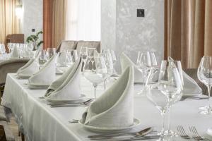 a table with wine glasses and napkins on it at Mir Luxe Plaza in Tashkent