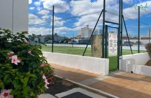 a batting cage with a gate and flowers at San Valentin Green Jade by Rentalfue in Corralejo