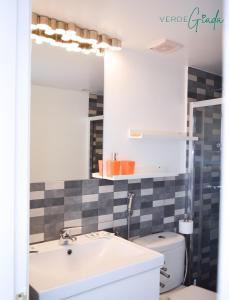 a bathroom with a sink and a toilet at San Valentin Green Jade by Rentalfue in Corralejo