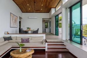 a living room with a couch and a table at Stunning SeaView Pool Villa in Haad Pleayleam