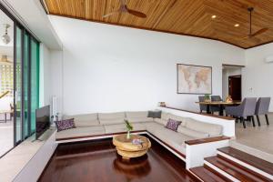 a living room with a couch and a table at Stunning SeaView Pool Villa in Haad Pleayleam +16 photos