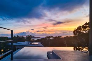 a view of a sunset from the deck of a house at Stunning SeaView Pool Villa in Haad Pleayleam