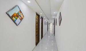 a hallway with paintings on the walls at FabHotel Amrit Grand in Gurgaon