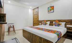 a bedroom with a large bed in a room at FabHotel Amrit Grand in Gurgaon