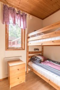 a bedroom with bunk beds and a window at First Camp Hökensås-Tidaholm in Tidaholm