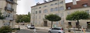 a street with cars parked in front of a building at STUDIO Dole Grevy deux étoiles, in Dole
