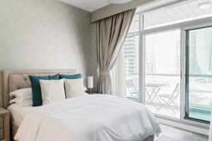 a bedroom with a bed and a large window at Boutique Living - Park Island in Dubai