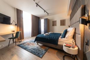 a hotel room with a bed and a desk and a table at MILU Apartments Sebastiana in Kraków