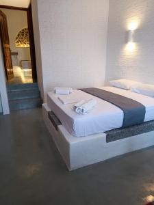 a bedroom with a bed with towels on it at Traditional house under the castle in Astypalaia Town