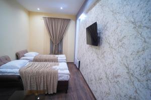 Ένα ή περισσότερα κρεβάτια σε δωμάτιο στο VN Hotel Vanadzor