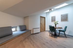 a room with a bed and a table and chairs at MILU Apartments Sebastiana in Krakow