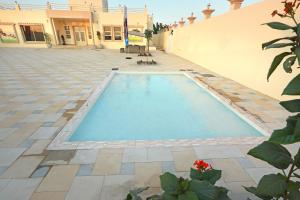 a swimming pool in the middle of a building at Al Wadi House , بيت الوادي in Ras al Khaimah