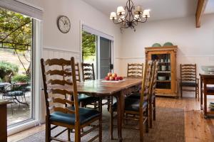 a dining room with a wooden table and chairs at Noonameena in Hepburn