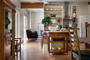 a kitchen and dining room with a table and chairs at Noonameena in Hepburn