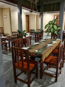 a dining room with a long table and chairs at Kendwa Cool and Calm Hotel limited in Kendwa
