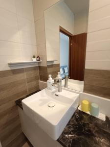 a bathroom with a white sink and a mirror at Water World Diving Resort in Green Island