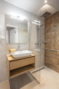 a bathroom with a sink and a glass shower at K46 Residence in Budapest