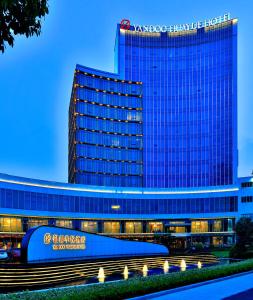 a large building with a sign in front of it at 银都酒店 Yandoo Hotel in Yiwu