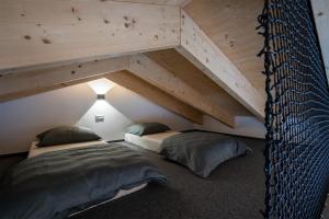 two beds in a room with a loft at Chalet Malino - Apartments in Ružomberok