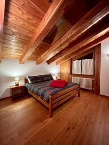 ein Schlafzimmer mit einem Bett und einer Holzdecke in der Unterkunft Maison Arcade in Challancin