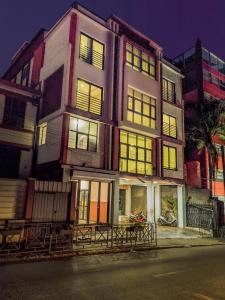 a building with many windows and a motorcycle parked in front of it at Valiha Serviced Apartments Antananarivo in Antananarivo