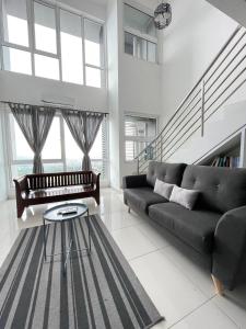 a living room with a couch and a table at Yenni Duplex @ DeCentrum, Kajang in Serdang