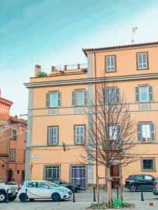 a large building with cars parked in front of it at SanFa Roof in Viterbo