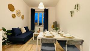 a living room with a table and a couch at JM Millennium Kawęczyńska 37 in Warsaw