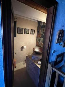 a bathroom with a sink and a toilet in a room at Mountain house in Palaios Agios Athanasios