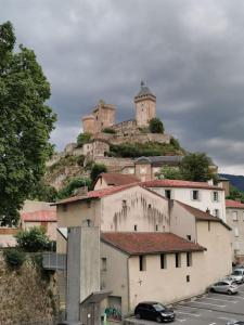 a building with a castle on top of a hill at Style et ambiance in Foix +29 photos